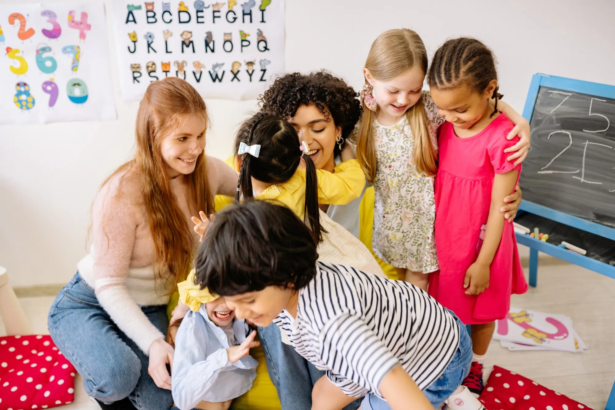 An educator reading with a small group of preschool children